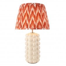 white ceramic table lamp with orange zigzag patterned shade