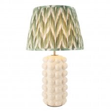 white ceramic table lamp with green zigzag patterned shade