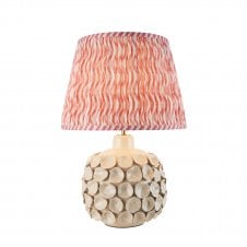 white ceramic table lamp with coral pink ripple pattern shade