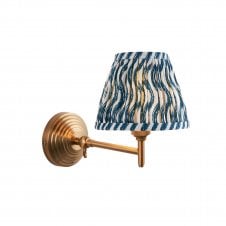 brass wall light with blue ripple pattern shade