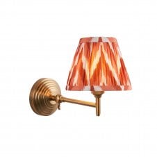 brass wall light with zigzag pattern orange shade