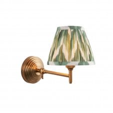 brass wall light with green zigzag pattern shade
