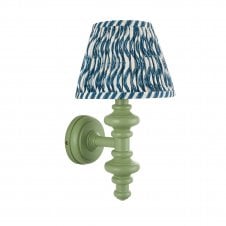 green wall light with blue ripple pattern shade