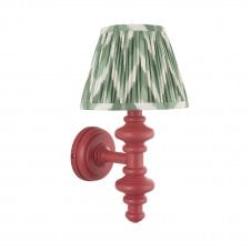 pink wall light with green zigzag pattern shade