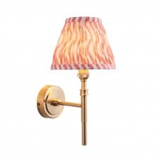 Brass wall light with pink pattern shade
