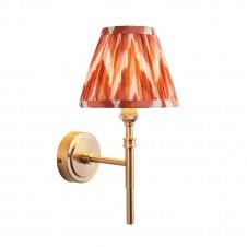 brass wall light with orange shade
