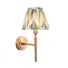 brass wall light with green zigzag pattern shade