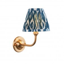 brass wall light with blue ikat pattern shade