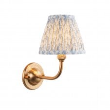 brass wall light with blue leaf pattern shade
