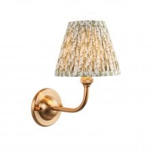 brass wall light with green leaf pattern shade