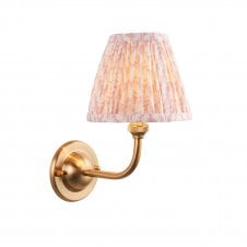brass wall light with peach pink leaf pattern shade