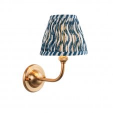 brass wall light with blue ripple pattern shade