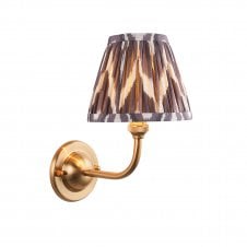 brass wall light with grey zigzag pattern shade