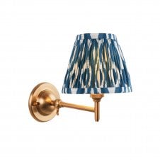 brass wall light with blue ikat pattern shade