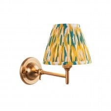 brass wall light with yellow & green ikat pattern shade