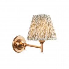 brass wall light with green leaf pattern shade