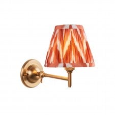 brass wall light with orange zigzag pattern shade