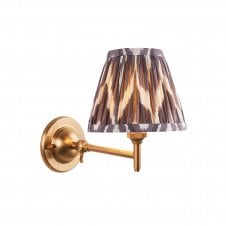 brass wall light with grey zigzag pattern shade