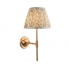 brass wall light with green leaf pattern shade