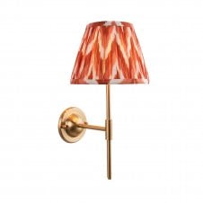 brass wall light with orange zigzag pattern shade