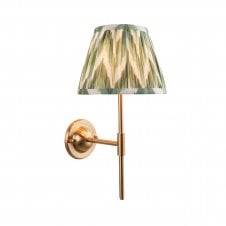 brass wall light with green zigzag pattern shade