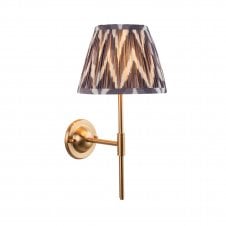 brass wall light with grey zigzag pattern shade