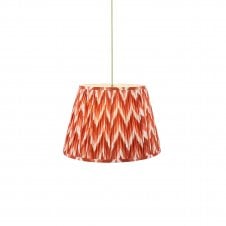 brass and green pendant with orange zigzag pattern shade