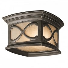 Gothic flush mount exterior light in bronze with amber tint glass