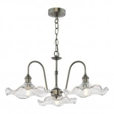 a traditional antique chrome three arm ceiling pendant with wavy edged glass shades