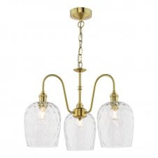 a vintage inspired brass ceiling pendant with three arms featuring dimpled glass dome shades