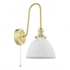a vintage-inspired wall light in natural brass with white ceramic dome shade with ribbed detail