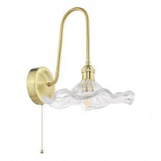 traditional wall light in a brass finish with a wavy edged glass shade