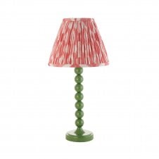 green table lamp with pink ikat pattern tapered shade