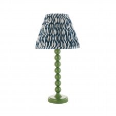 green table lamp with blue ripple pattern tapered shade