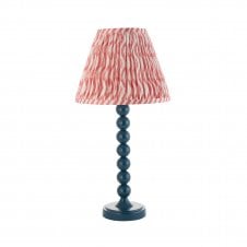 blue table lamp with pink ripple pattern shade