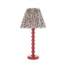pink table lamp with vintage white tapered shade