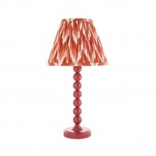 pink table lamp with orange zigzag pattern shade