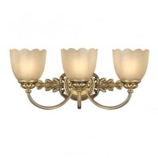 traditional over mirror bathroom wall light in brass with amber glass shades