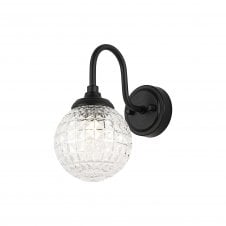 black curved arm wall light with round cross-pattern glass shade