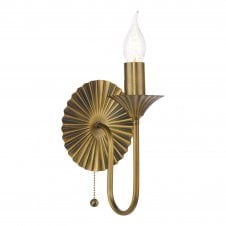 an antique bronze traditional style wall light with decorative sunburst backplate with candle style bulb