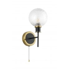 single wall light in brass and black with round dimpled clear glass shade