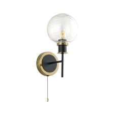 single wall light in brass and black with ribbed glass shade
