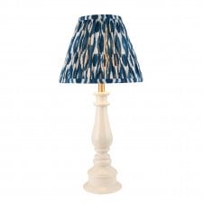 white spindle table lamp with blue ikat pattern shade
