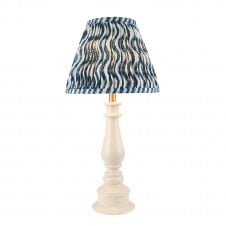 white spindle table lamp with blue ripple pattern shade