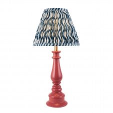 pink spindle table lamp with blue ripple pattern shade