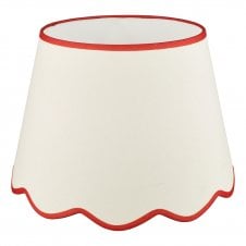 A large, neutral scallop shade lamp shade with red edge detail
