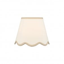 A neutral scalloped edge table lamp shade with taupe accent edging