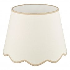 A large, neutral scallop shade lamp shade with taupe edge detail