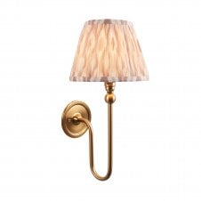 brass wall light with neutral ikat pattern shade 