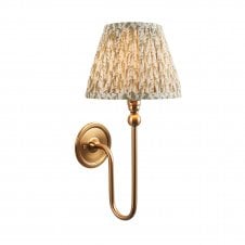 brass wall light with green leaf pattern shade
